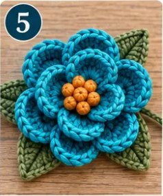 Step 5: the teal flower with its amber center and green leaves behind it